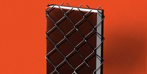 a black hardcover book wrapped in fencing against a red backdrop