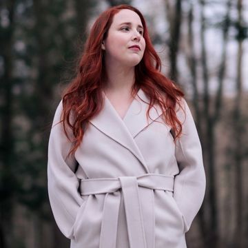 dylan farrow stands in a yard with tall trees behind her dylan farrow stands in a yard with tall trees behind her