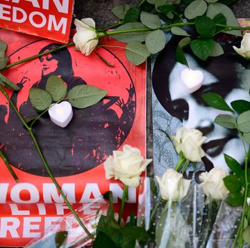 Masha Amini Protest In Istanbul memorial photos of mahsa amini and white roses