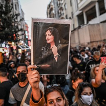TOPSHOT-TURKEY-IRAN-WOMEN-RIGHTS-PROTEST topshot a protester holds a portrait of mahsa amini during a demonstration in support of amini, a young iranian woman who died after being arrested in tehran by the islamic republic's morality police, on istiklal avenue in istanbul on september 20, 2022 amini, 22, was on a visit with her family to the iranian capital when she was detained on september 13 by the police unit responsible for enforcing iran's strict dress code for women, including the wearing of the headscarf in public she was declared dead on september 16 by state television after having spent three days in a coma photo by ozan kose afp photo by ozan koseafp via getty images