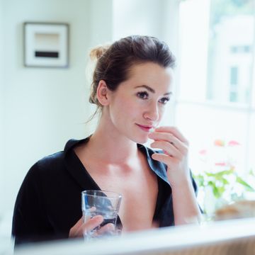 Woman taking vitamins and supplements. woman taking vitamins and supplements
